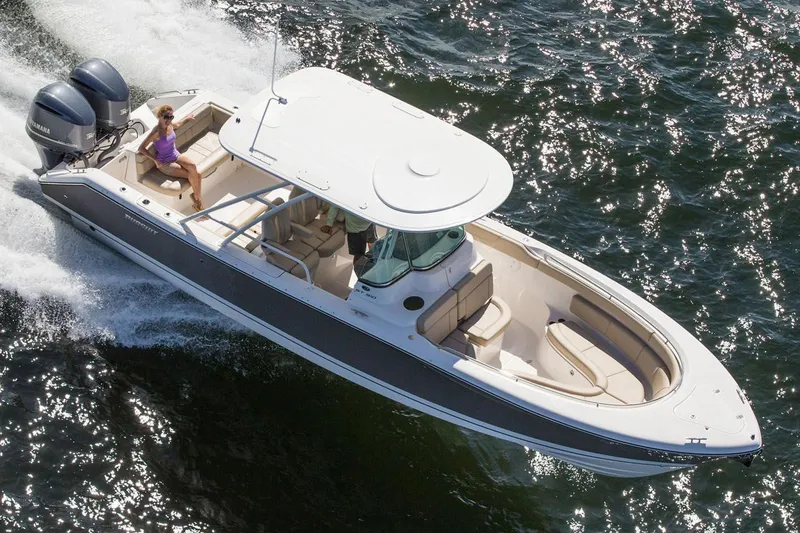 Slide: The Image of Manufacturer Provided Image: 2015 Pursuit ST 310 Sport boat cruising on water. - 24