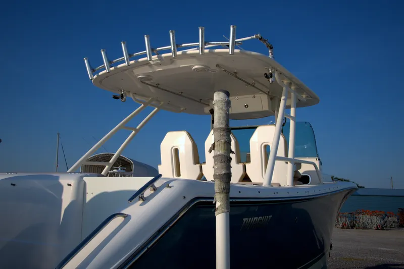 Slide: The Image of 2015 Pursuit ST 310 Sport boat docked under clear blue sky. - 28