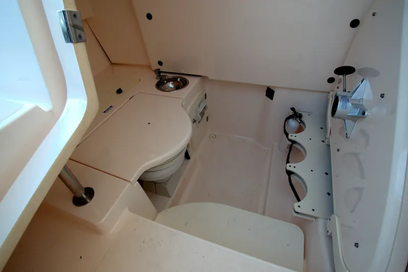 Slide: The Image of 2015 Pursuit ST 310 Sport boat interior with compact bathroom amenities. - 22