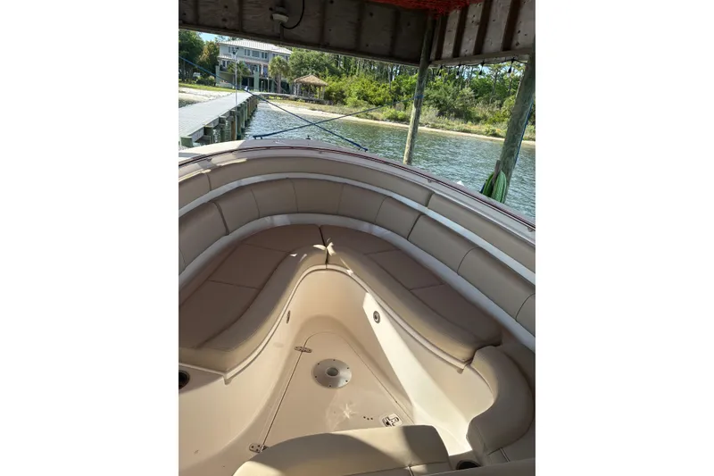 Slide: The Image of 2015 Pursuit ST 310 Sport boat docked by the water. - 5