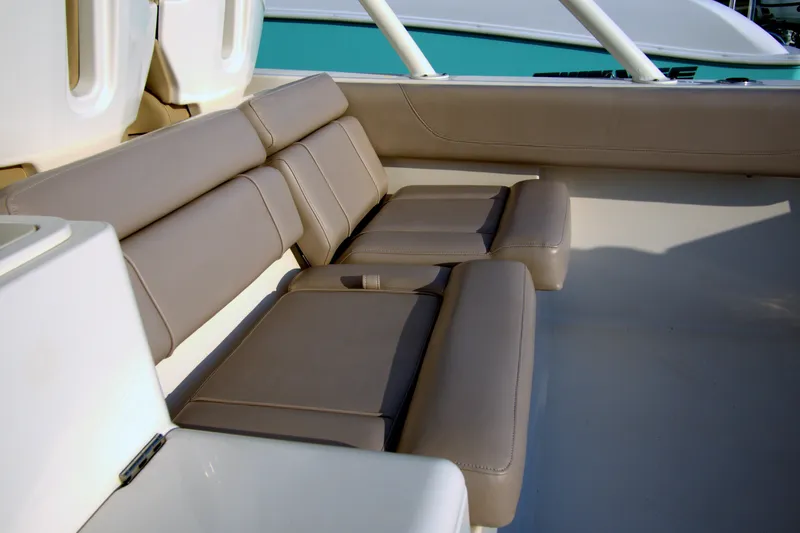 Slide: The Image of 2015 Pursuit ST 310 Sport boat interior with beige cushioned seating. - 43