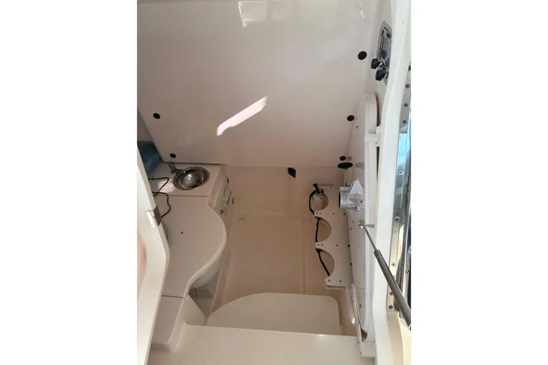 Slide: The Image of Control panel of a 2015 Pursuit ST 310 Sport boat with steering wheel and displays. - 7