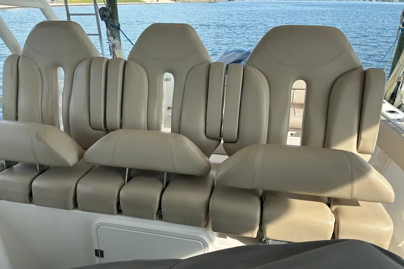 Slide: The Image of 2015 Pursuit ST 310 Sport boat docked under a wooden shelter with Raymarine equipment. - 8