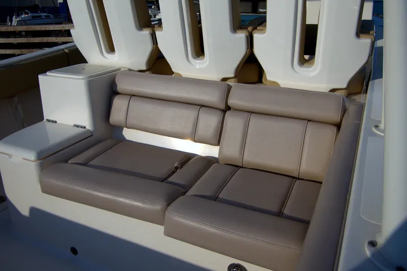 Slide: The Image of 2015 Pursuit ST 310 Sport boat interior with cushioned seating and storage. - 39