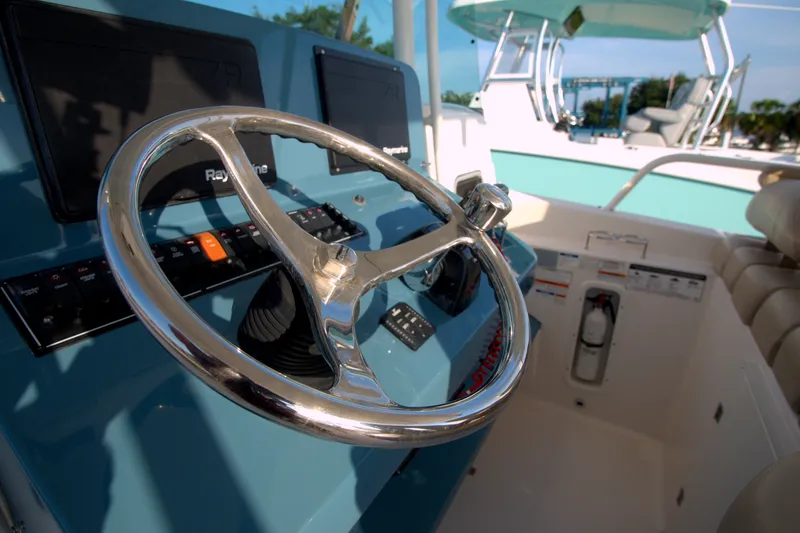 Slide: The Image of Steering wheel of 2015 Pursuit ST 310 Sport boat with Raymarine electronics. - 37