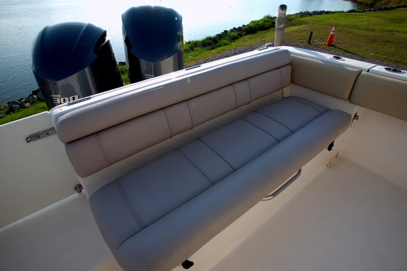 Slide: The Image of 2015 Pursuit ST 310 Sport boat with cushioned seating and dual Yamaha 300 engines. - 42