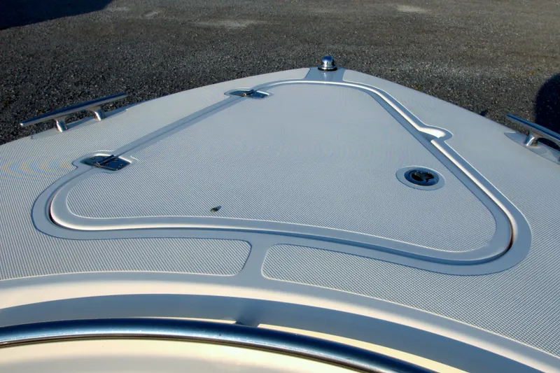 Slide: The Image of Bow deck of 2015 Pursuit ST 310 Sport boat with sleek design and cleats. - 24