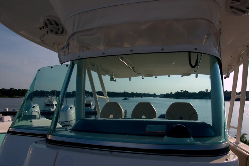 Slide: The Image of 2015 Pursuit ST 310 Sport boat interior with scenic waterfront view. - 35