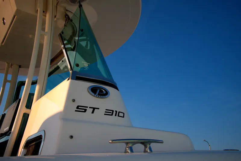 Slide: The Image of 2015 Pursuit ST 310 Sport boat against clear blue sky. - 29