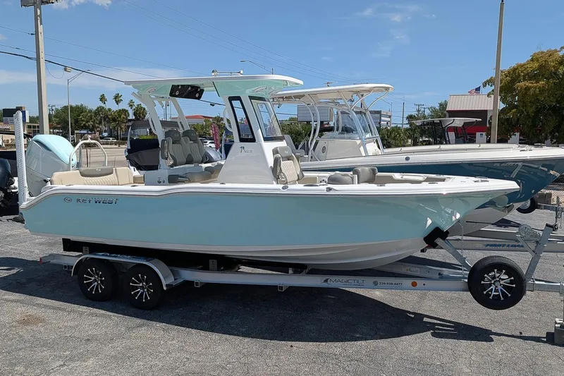 The Image of 2026 Key West 249 FS boat on trailer, displayed outdoors under clear sky. - 0