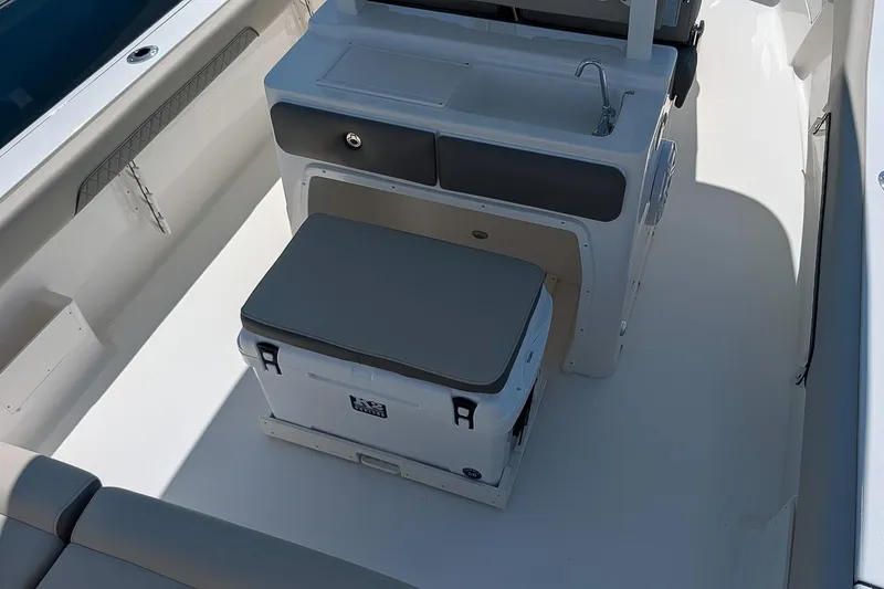 Slide: The Image of 2026 Key West 249 FS boat interior with seating, storage, and sink. - 14