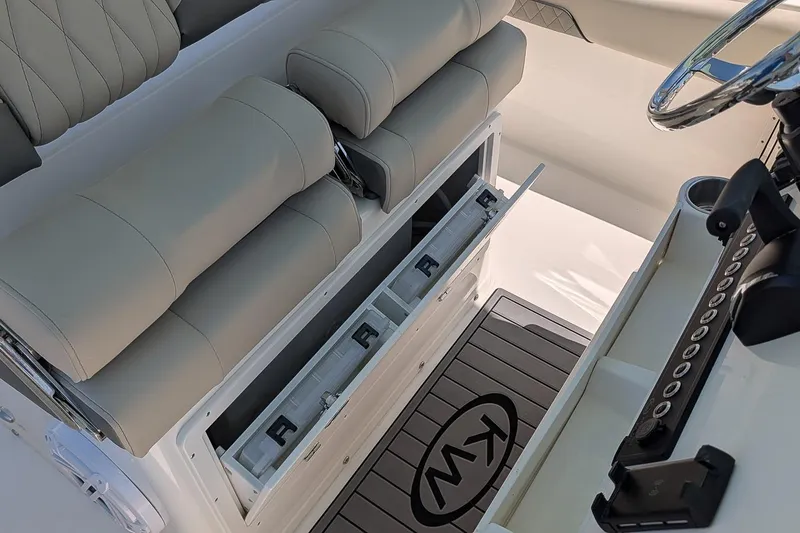 Slide: The Image of 2026 Key West 249 FS boat interior with cushioned seating and storage compartments. - 17