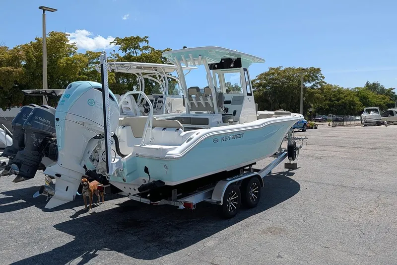 Slide: The Image of 2026 Key West 249 FS boat on trailer, featuring Yamaha outboard motor, parked outdoors. - 2