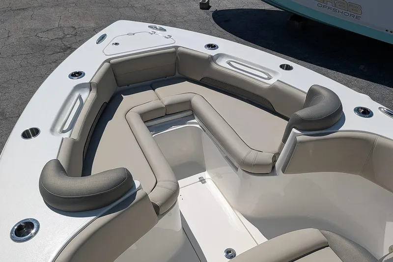 Slide: The Image of 2026 Key West 249 FS boat interior with cushioned seating and cup holders. - 22