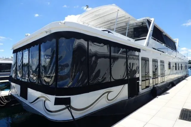 The Image of 2009 Sumerset 19x105 houseboat docked, featuring sleek design and spacious upper deck. - 0