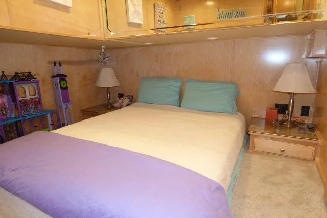 Slide: The Image of Cozy bedroom in 2009 Sumerset 19x105 houseboat with wooden walls and colorful decor. - 10