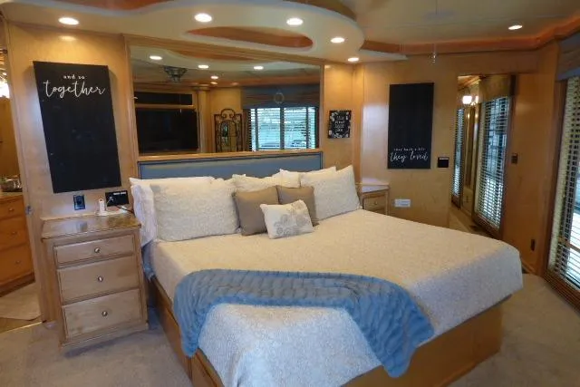 Slide: The Image of Luxurious bedroom in a 2009 Sumerset 19x105 houseboat with elegant decor and cozy bedding. - 12