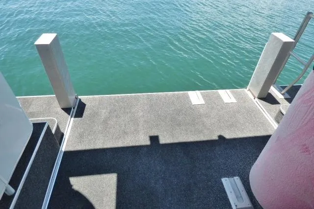 Slide: The Image of 2009 Sumerset 19x105 houseboat deck overlooking calm blue water. - 15