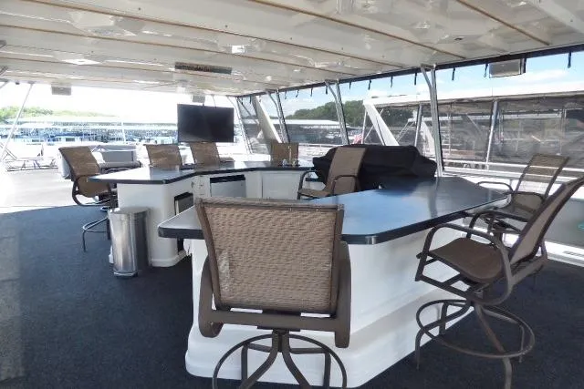 Slide: The Image of Spacious 2009 Sumerset 19x105 houseboat interior with bar seating and outdoor views. - 17