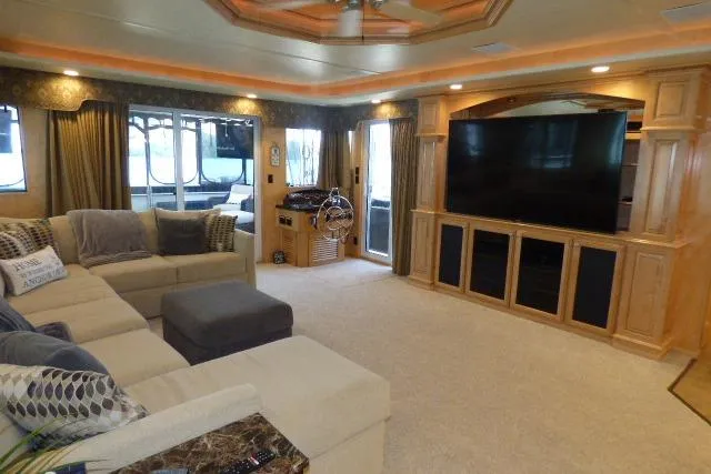 Slide: The Image of Luxurious 2009 Sumerset 19x105 houseboat interior with spacious living area and large TV. - 3