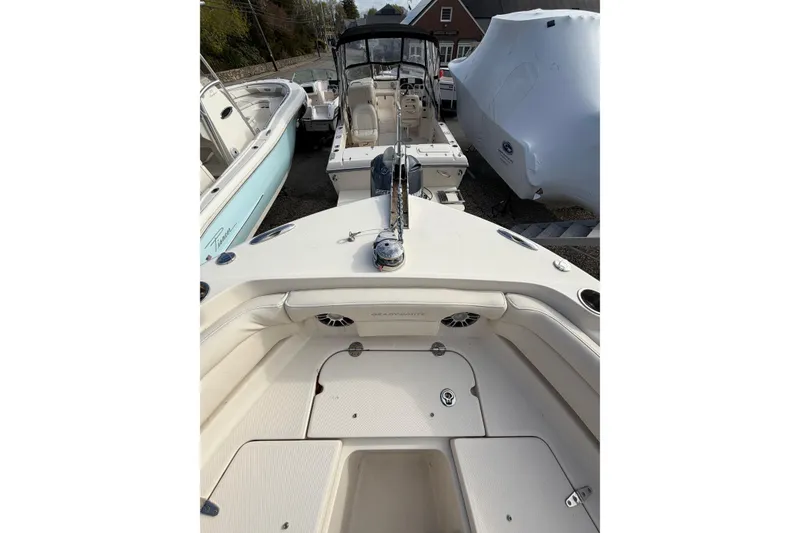 Slide: The Image of 2012 Grady-White Freedom 235 boat, spacious deck, parked among other boats. - 10