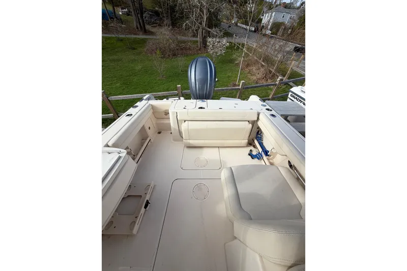 Slide: The Image of 2012 Grady-White Freedom 235 boat interior with seating and motor, viewed from above. - 12