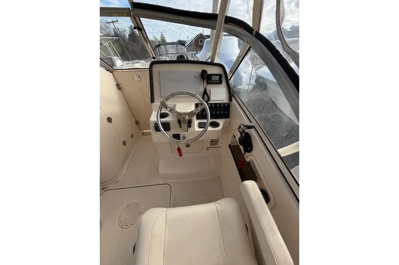 Slide: The Image of Interior view of 2012 Grady-White Freedom 235 boat cockpit with steering wheel and controls. - 8
