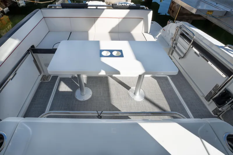 Slide: The Image of 2024 Jeanneau Leader 9.0 WA Series 2 boat interior with seating and table. - 24