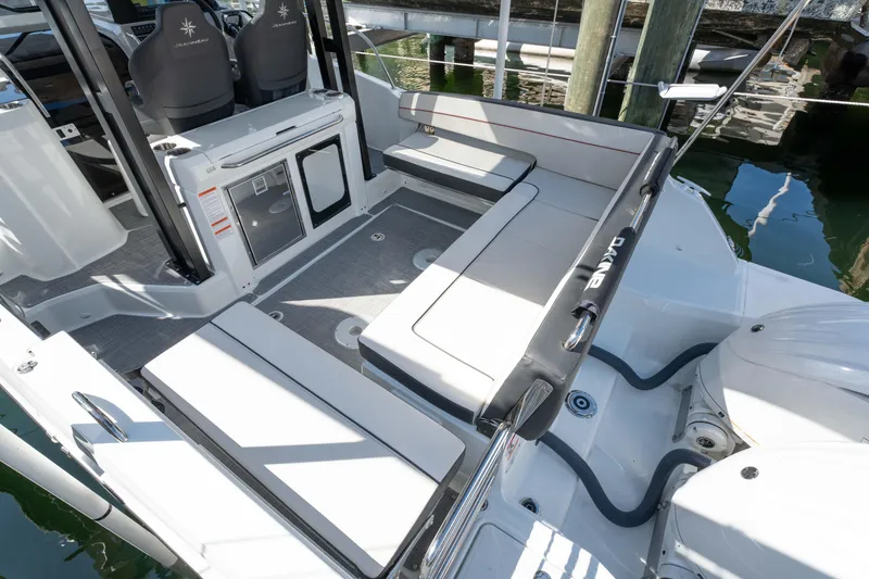 Slide: The Image of 2024 Jeanneau Leader 9.0 WA Series 2 boat interior with seating and helm. - 4