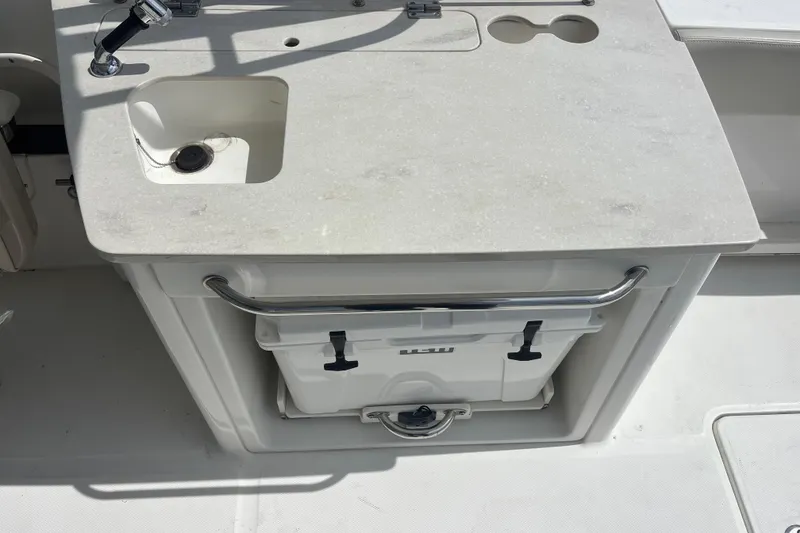 Slide: The Image of Boston Whaler 270 Vantage 2019 boat sink and cooler setup on deck. - 11