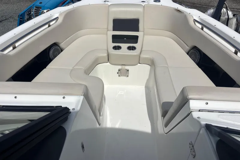 Slide: The Image of 2019 Boston Whaler 270 Vantage boat interior with cushioned seating and cup holders. - 12