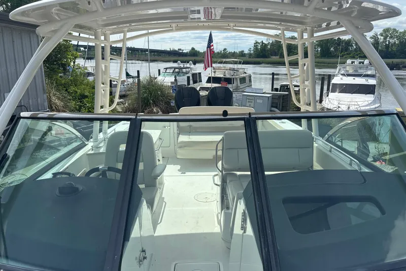 Slide: The Image of 2019 Boston Whaler 270 Vantage boat docked, showcasing spacious seating and sleek design. - 14