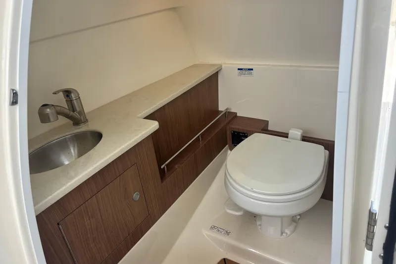 Slide: The Image of 2019 Boston Whaler 270 Vantage boat bathroom with sink and toilet. - 15
