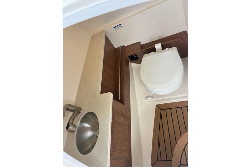 Slide: The Image of 2019 Boston Whaler 270 Vantage boat bathroom with sink and toilet. - 16