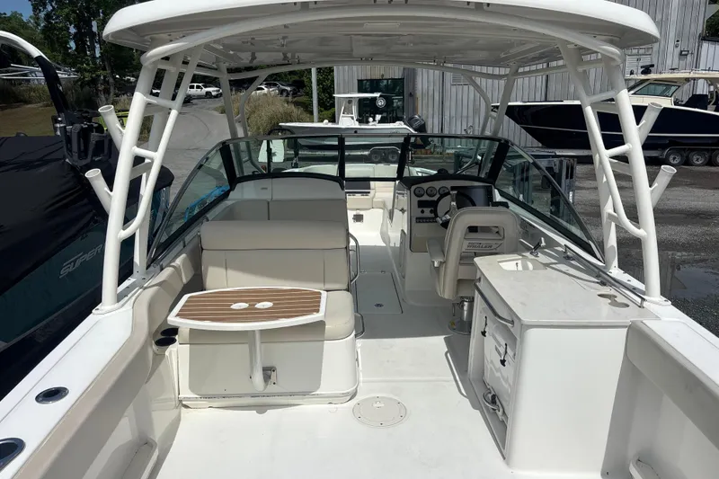 Slide: The Image of 2019 Boston Whaler 270 Vantage boat interior with seating, table, and helm. - 5