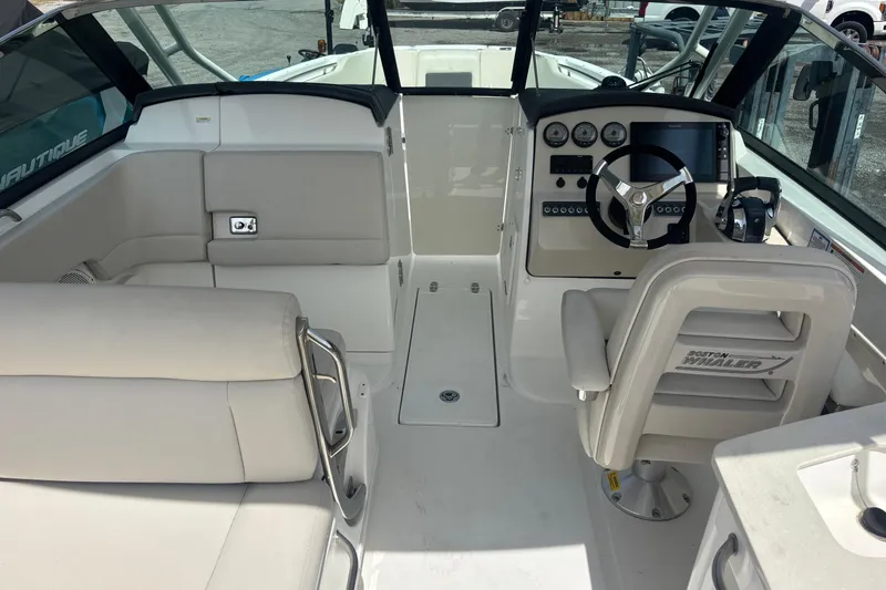 Slide: The Image of 2019 Boston Whaler 270 Vantage boat interior with helm, seating, and controls. - 6