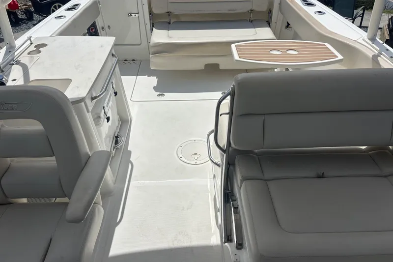 Slide: The Image of 2019 Boston Whaler 270 Vantage interior with seating and table, showcasing spacious design. - 7