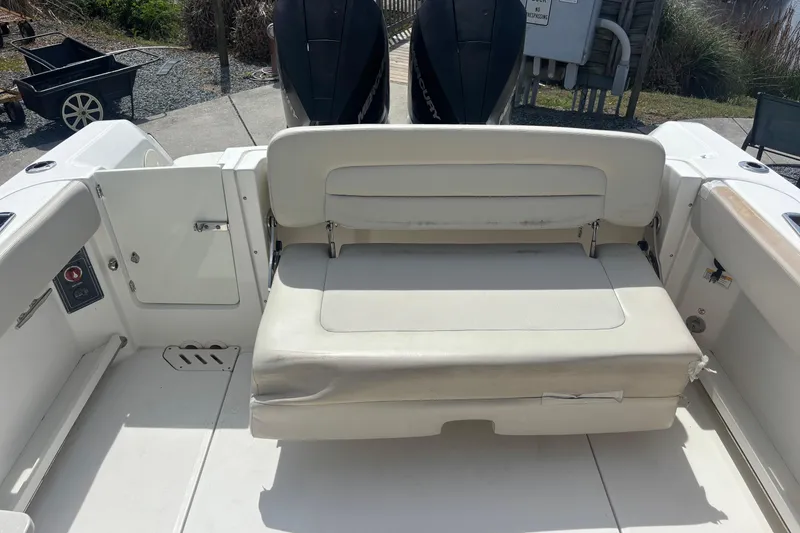 Slide: The Image of 2019 Boston Whaler 270 Vantage boat interior with cushioned seating and storage. - 9