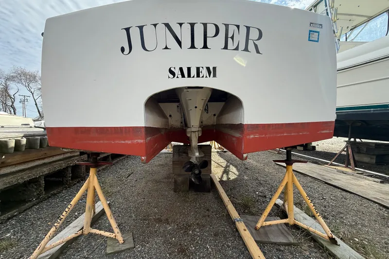 Slide: The Image of 2024 Hylan Bowler boat "Juniper" on stands, rear view, Salem location. - 14
