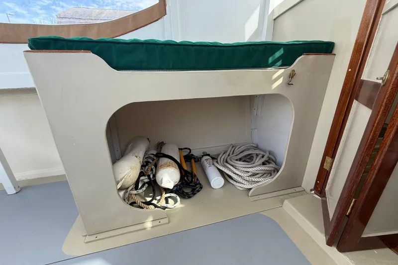 Slide: The Image of Storage compartment on a 2024 Hylan Bowler boat with ropes and fenders. - 22