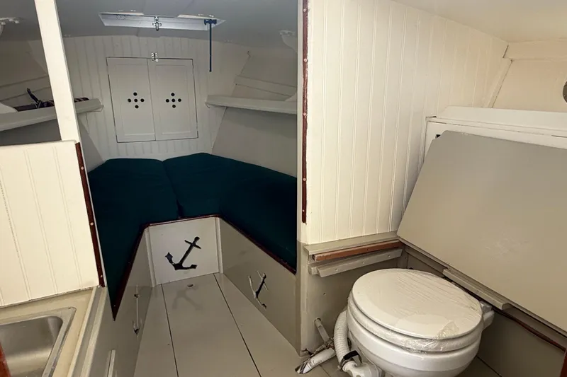 Slide: The Image of 2024 Hylan Bowler boat interior with compact cabin, bed, and marine toilet. - 27