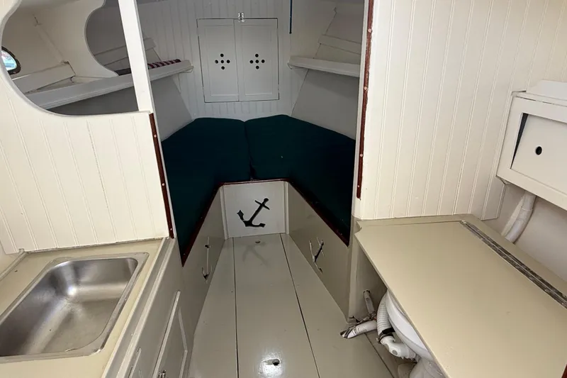 Slide: The Image of 2024 Hylan Bowler boat interior with compact cabin, sink, and anchor decor. - 28