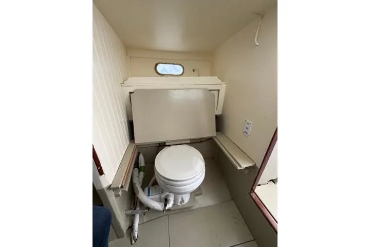 Slide: The Image of 2024 Hylan Bowler boat interior with compact marine toilet setup. - 29