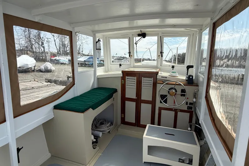 Slide: The Image of Interior of a 2024 Hylan Bowler boat with steering wheel and seating area. - 3