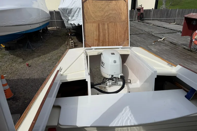 Slide: The Image of 2024 Hylan Bowler boat with Suzuki outboard motor in a storage yard. - 37