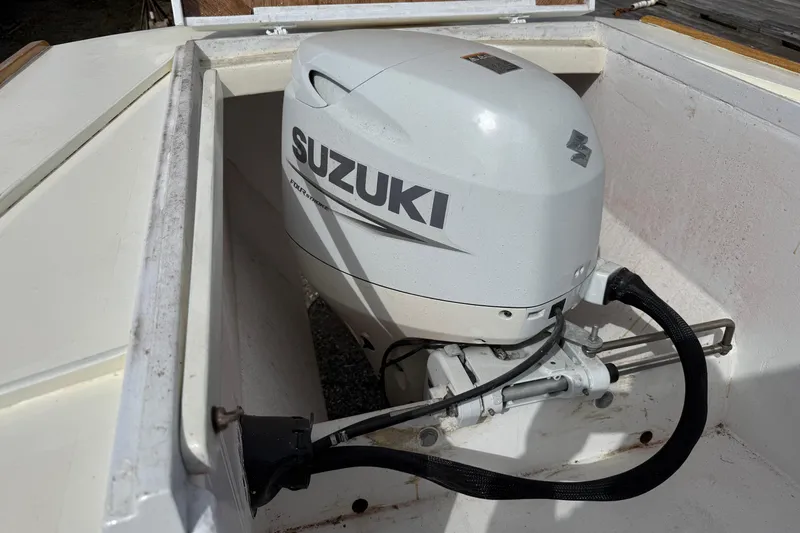 Slide: The Image of 2024 Hylan Bowler boat with Suzuki outboard motor in compartment. - 38