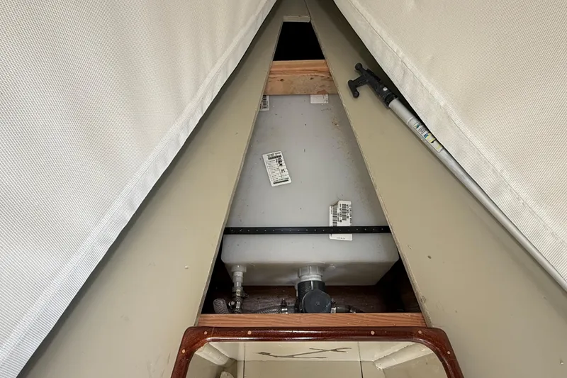 Slide: The Image of 2024 Hylan Bowler interior showing storage compartment with equipment and labels. - 39