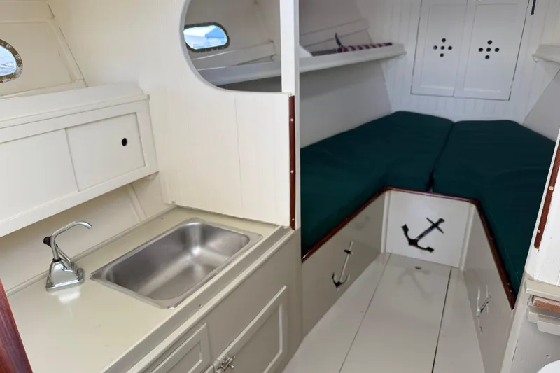 Slide: The Image of 2024 Hylan Bowler boat interior with kitchenette and cozy sleeping area. - 4