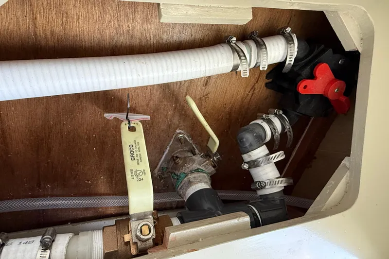 Slide: The Image of Plumbing system inside 2024 Hylan Bowler boat, featuring hoses and valves. - 41