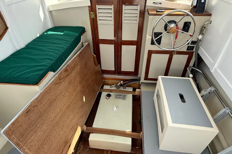 Slide: The Image of Interior of 2024 Hylan Bowler boat with steering wheel and storage compartments. - 46